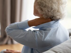 woman rubbing her neck